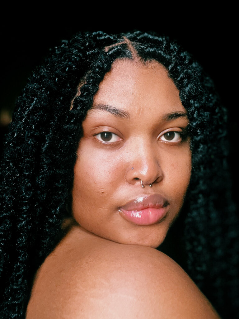 body politics and dysmorphia: Me in December 2023. I have faux-locs on. This is one of my favourite pictures of myself because I looked and felt like me completely