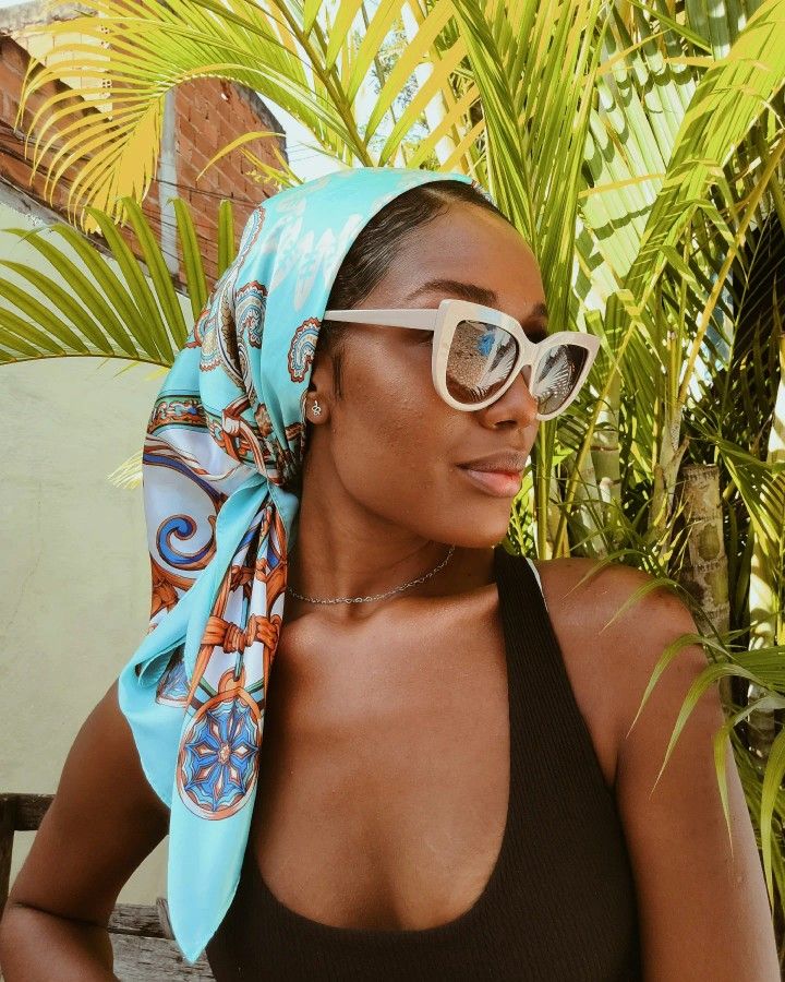 Silk scarf as a travel bag essential - Clara Fernandes in a silk scarf via Pinterest