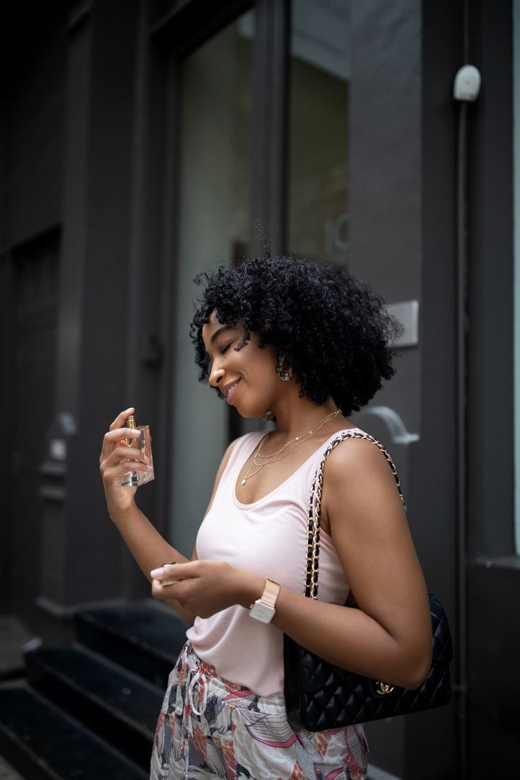 Travel bag essentials - Tiff Benson spraying the Roja Dove Elixir perfume via Tiff Benson on Pinterest