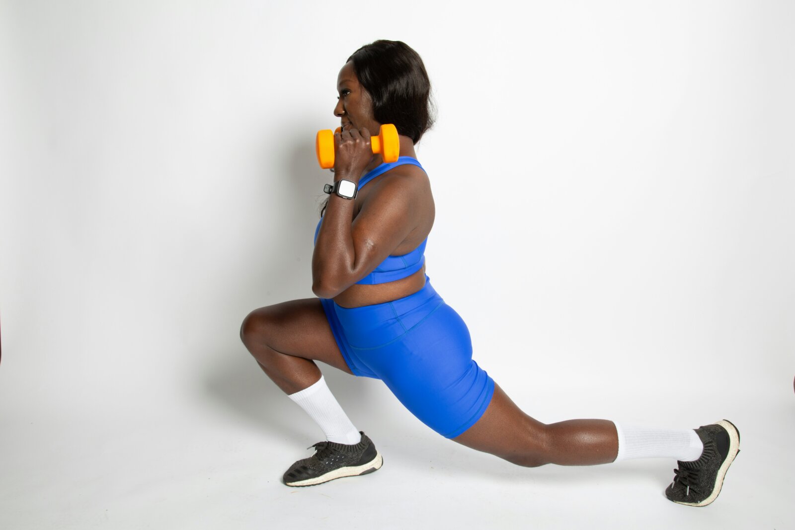 A black woman doing lunges by April Laugh via Unsplash