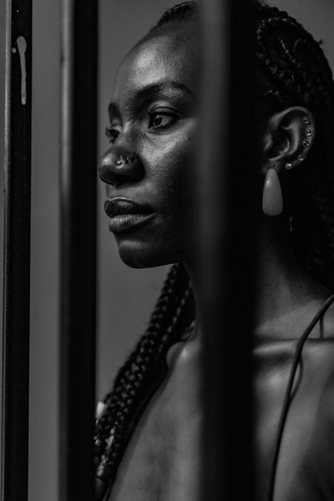 Black woman staring by Lisa Marie Theck via Unsplash