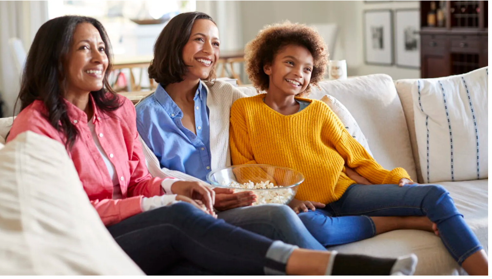 Black mother, her daughter and granddaughter watching TV, via Getty Images/iStockphoto
