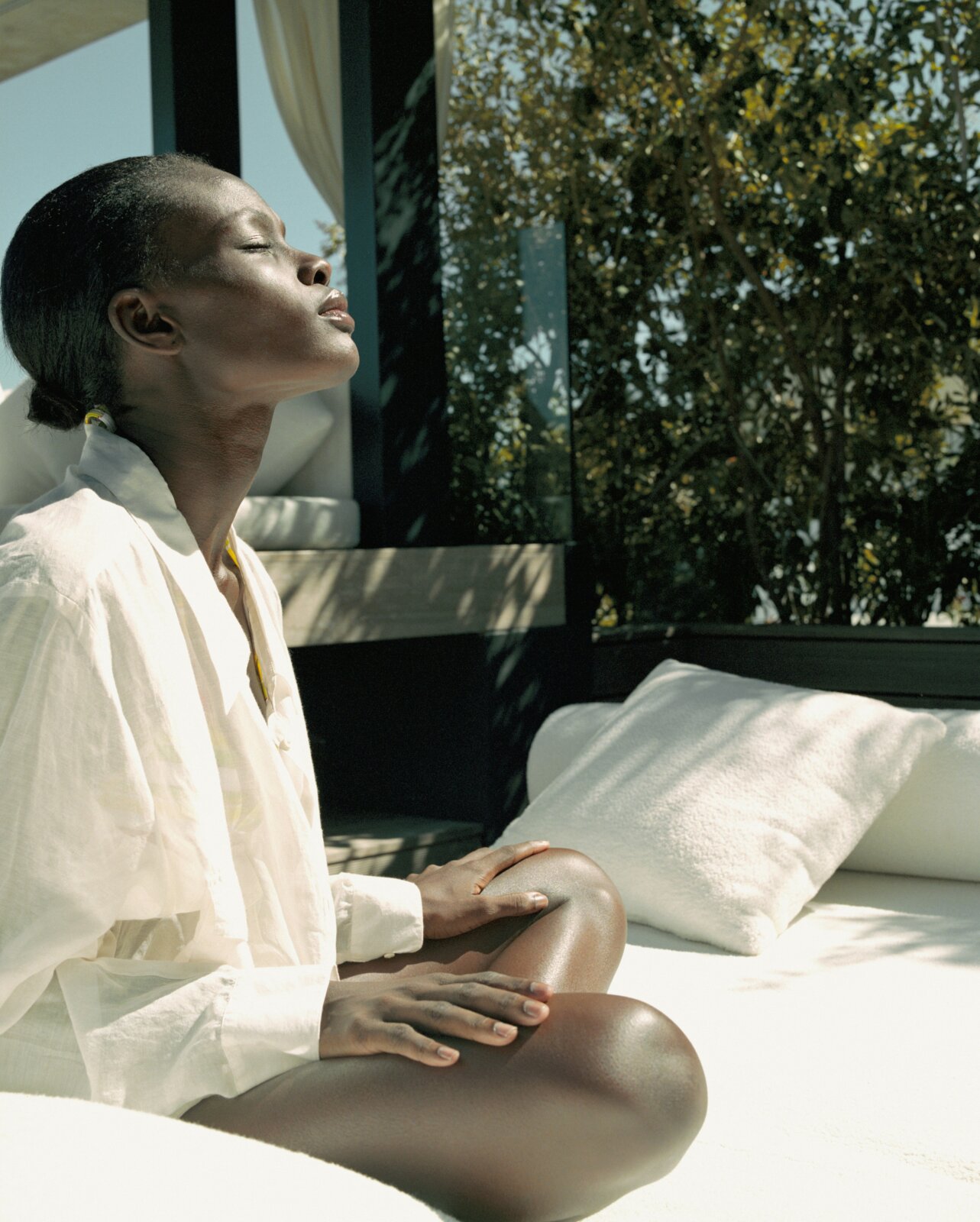 Skin cancer awareness - Woman sitting on a bed facing the sun by Getty Images via Unsplash