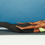 A black woman doing a yoga pose via Self.com