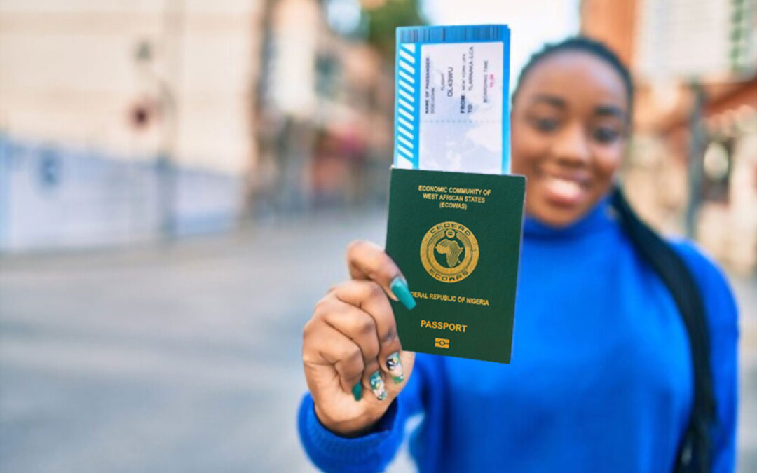 A black woman holding up a Nigerian passport via Rex Clarke