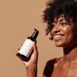 black woman holding a haircare bottle via freepik