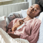 A black woman in bed via Unsplash