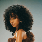 Tyla in a curly wig via Tyla on Instagram