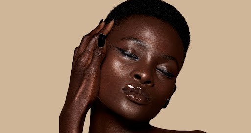 A darks ksinned model with glowing skin via Unsplash