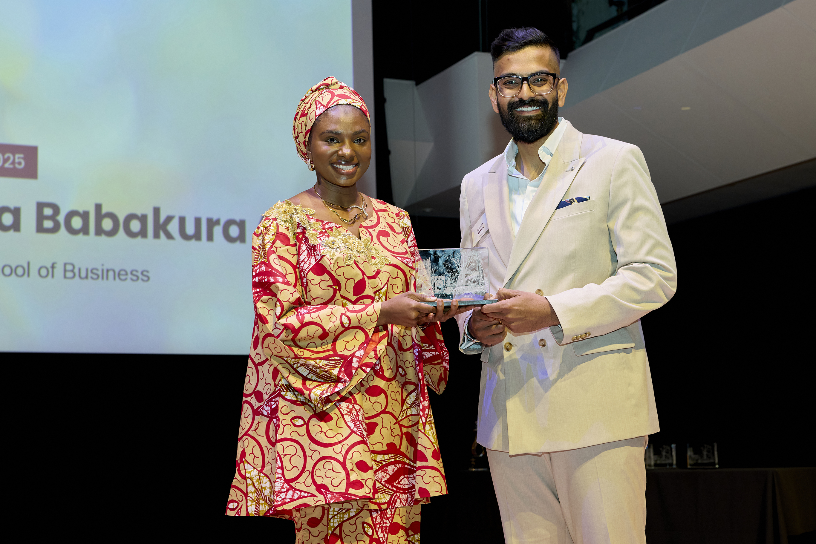Fatima Babakura receiving the McMaster University Arch award for Timabee.