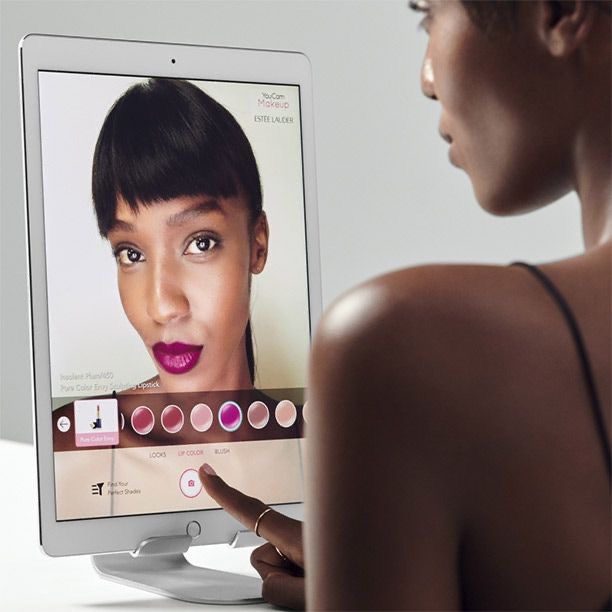 Black woman testing shades of lipstick virtually via Estee Lauder on Pinterest