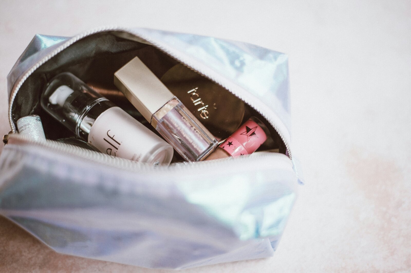 Cosmetics in a grey bag by Annie Spratt via Unsplash