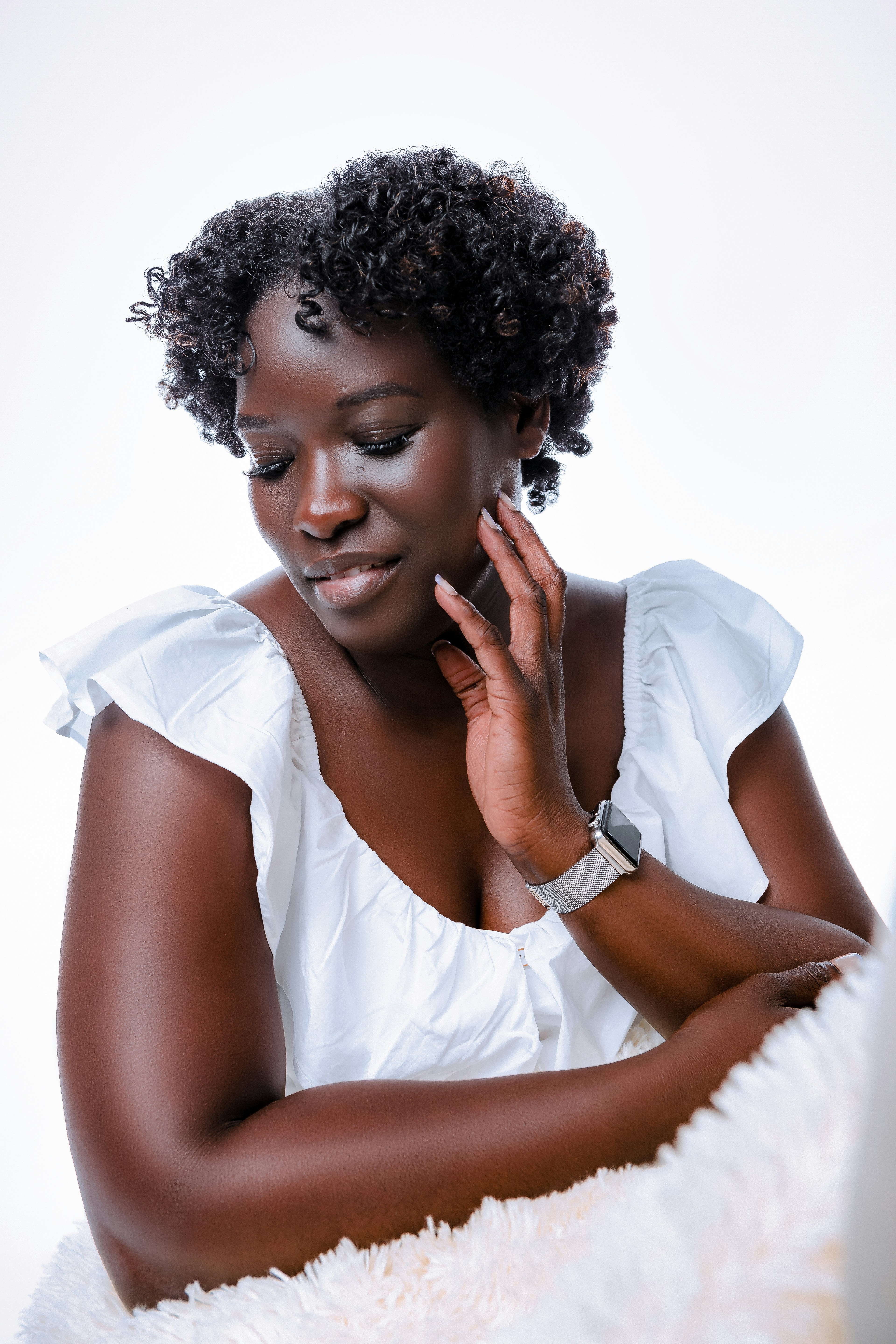 A dark-skinned woman in a white dress by Dellon Thomas via Unsplash+