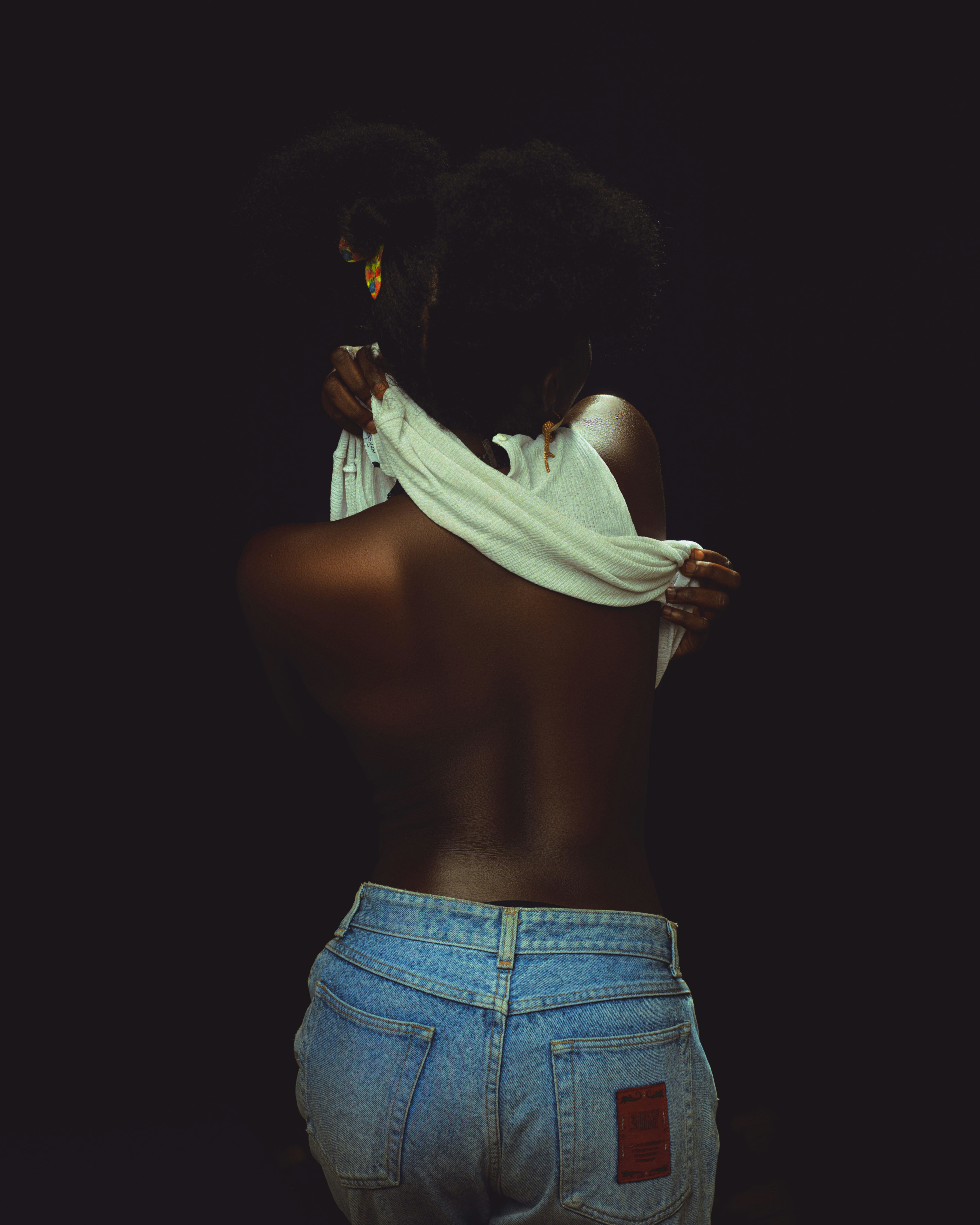 Woman with her back turned to the camera by Godfred Kwakye via Unsplash