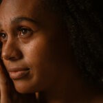 A close-up shot black woman with regular skin via Pablo Merchan Motes via unsplash