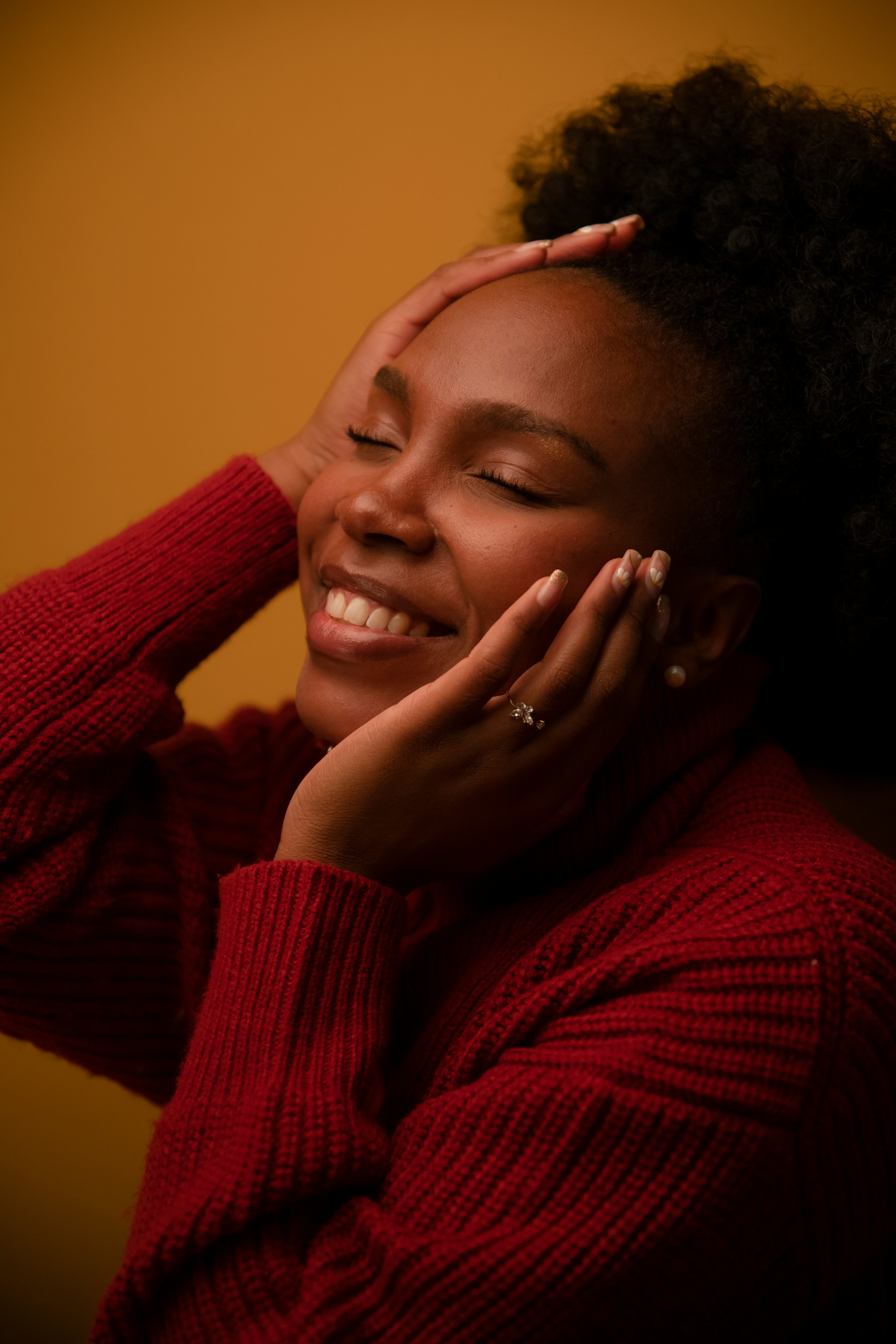 Woman smiling with hands on her face by Pablo Merchan Montes via unsplash