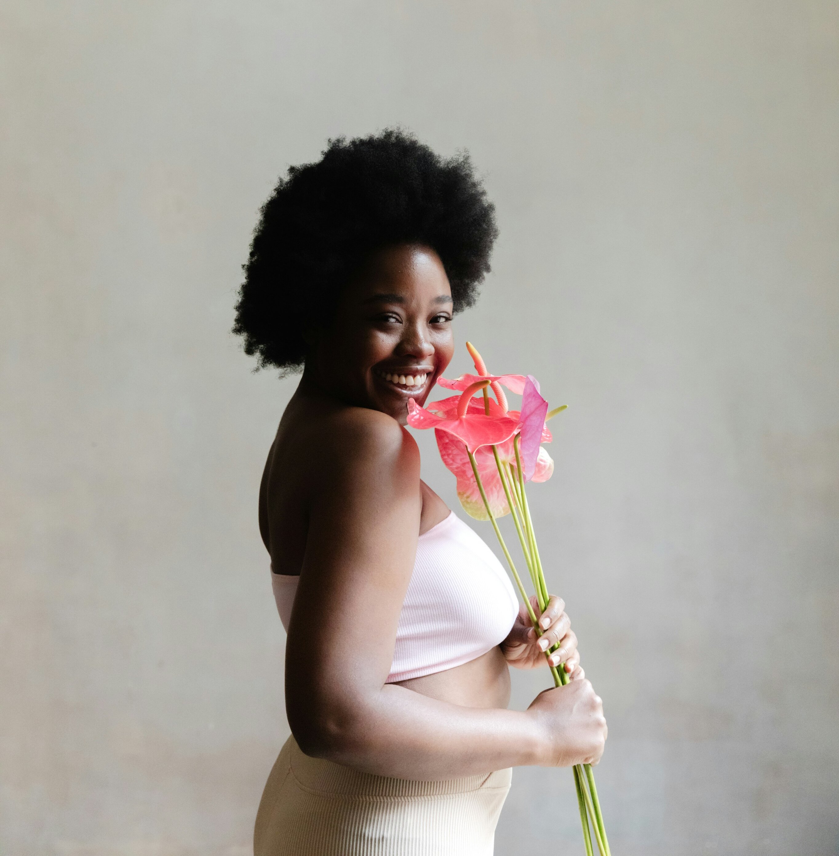 My beauty confessions on being beautiful : Woman holding flowers in her hands by Thais Varela via Unsplash