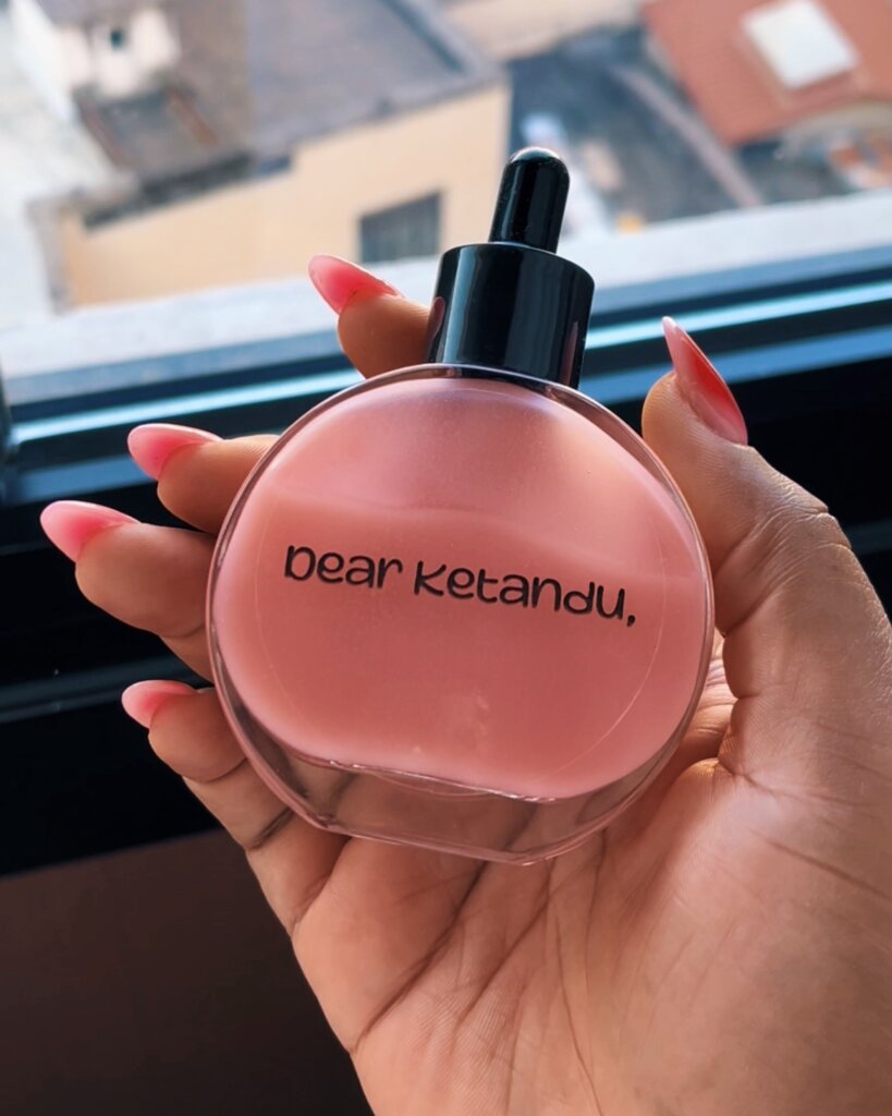 THB Scalp Drops by Dear Ketandu being held against a window