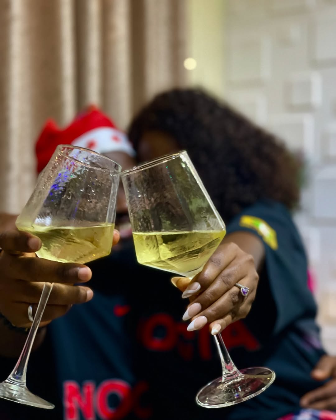 Temi & Wumi Tuase-Fosudo holding glasses of wine via Wumi Tuase-Fosudo