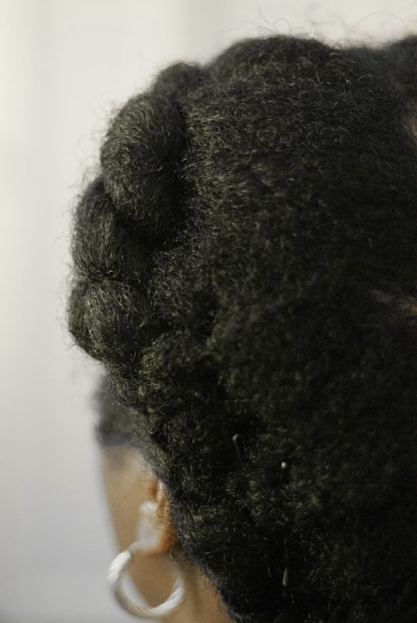A back shot of a black woman’s 4C hair by Leighann Blackwood via Unsplash+