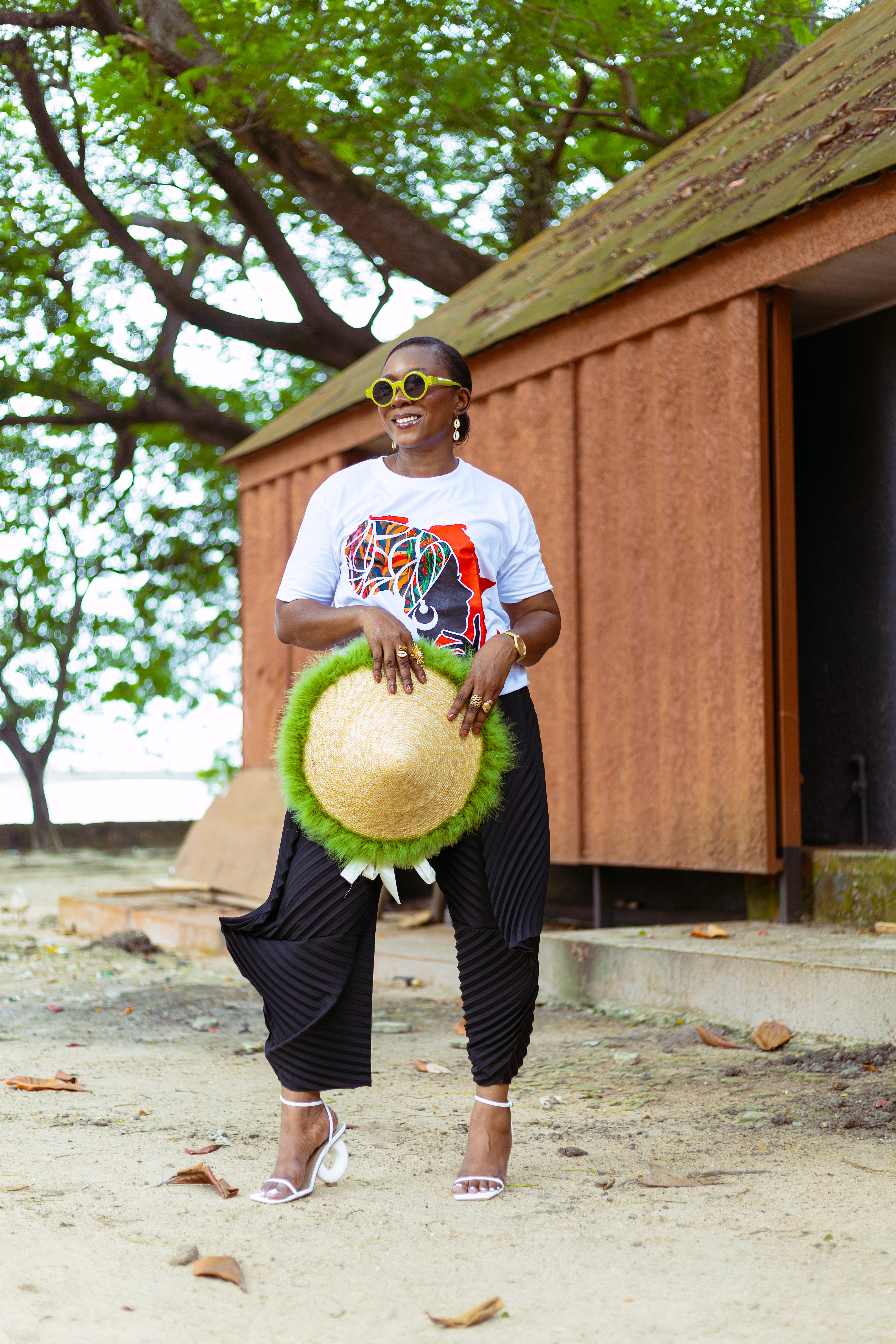 Fashion stylist, Rhoda Ebun, wearing MOBOS fashion motif t-shirt, Aladin trousers and Bland 2 Glam accessories.