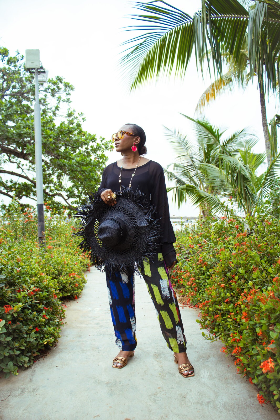 Fashion stylist, Rhoda Ebun, wearing Amede sheer chiffon blouse and batik trousers. Bland 2 Glam accessories.