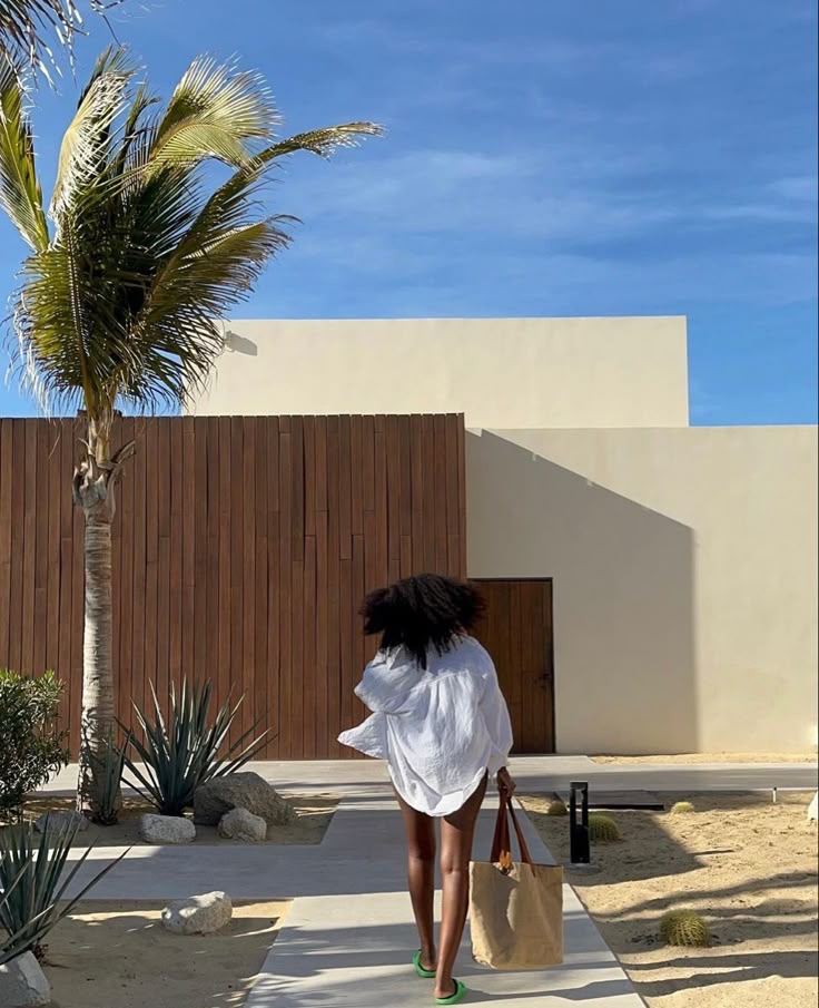 Image credit: Back view of a Black woman holding a rattan tote bag by Fae via Pinterest