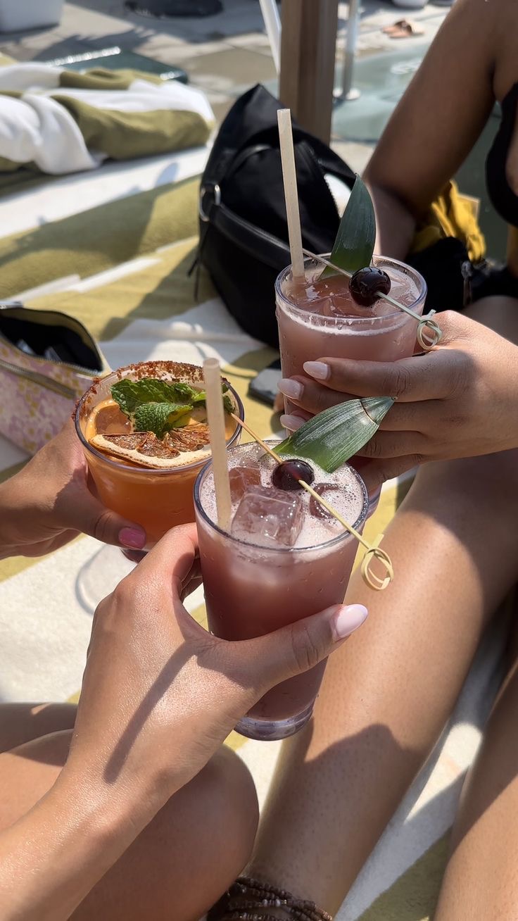 Women clinking glasses of cocktails via Pinterest