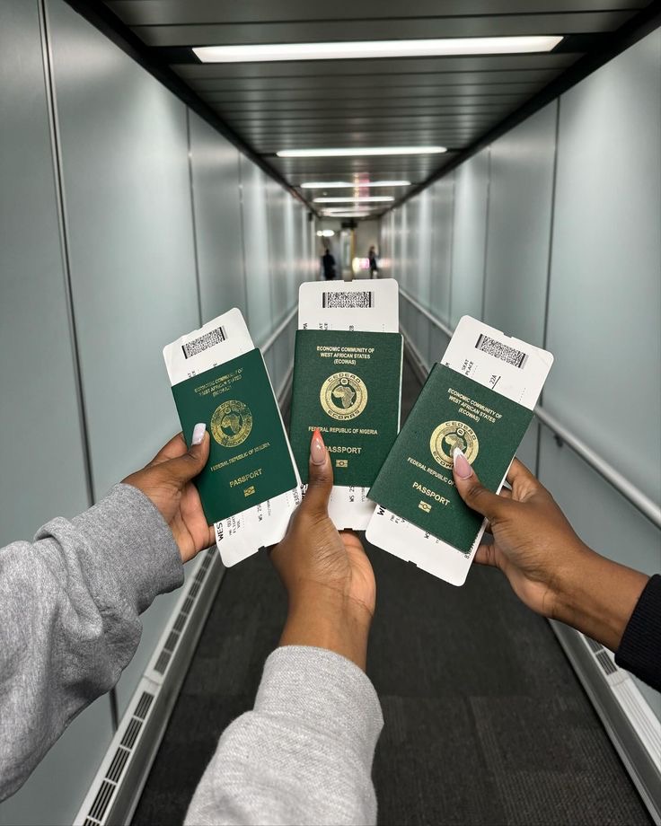 Three women holding Nigerian passports by Stephanie Moka via Pinterest
