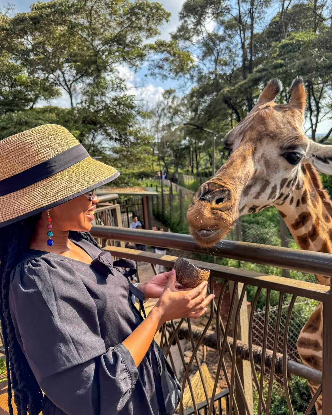 Black woman feeding a giraffe in Kenya via @beautifulstruggle1818 on Instagram