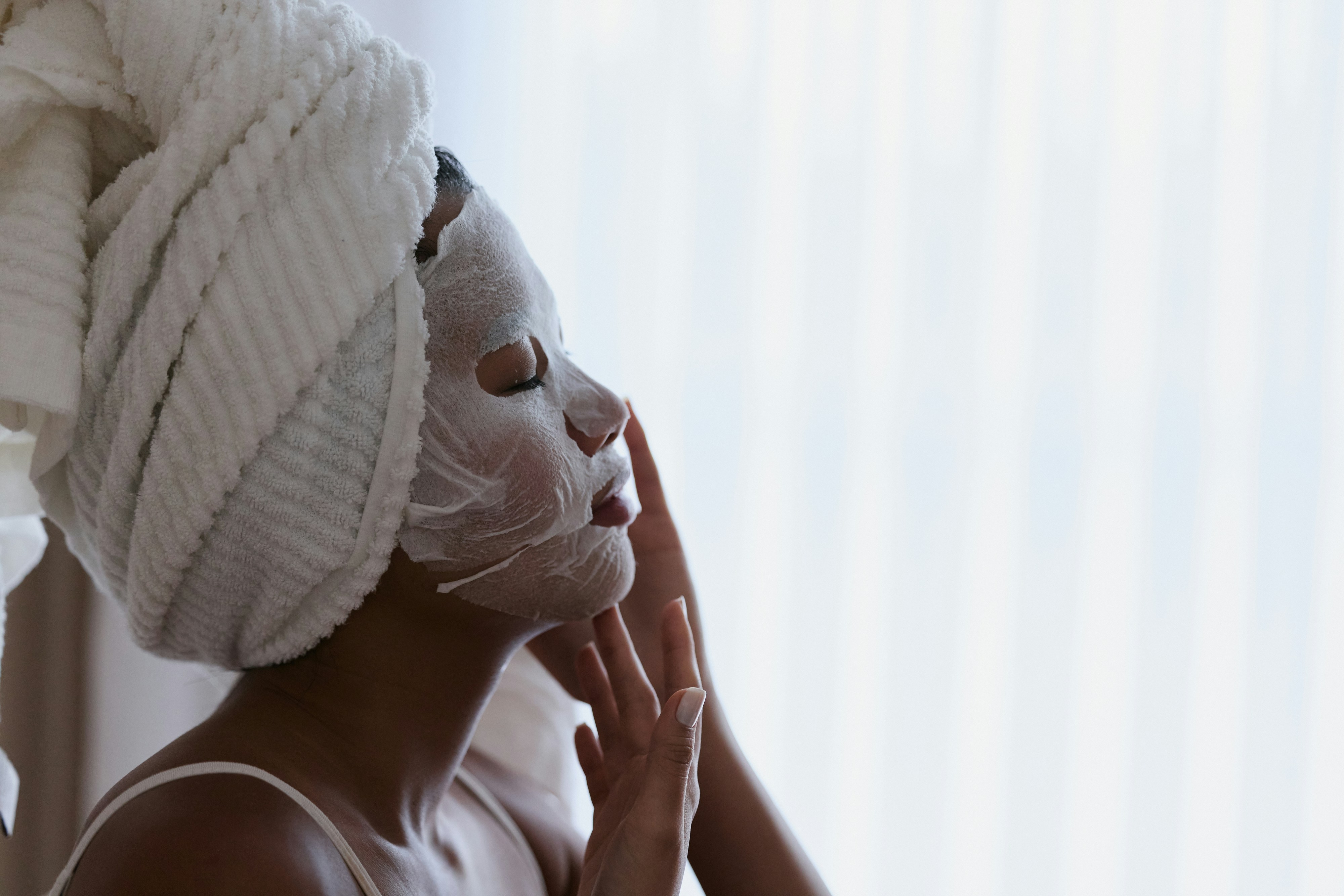 A woman with a towel wrapped around her head by Nathalia Blauth via Unsplash