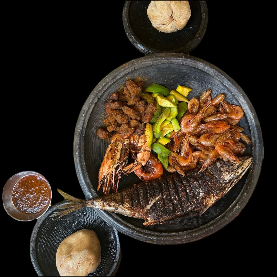 A plate of kenkey, shito, and grilled fish by Selassie Atadike @satadike via Instagram.