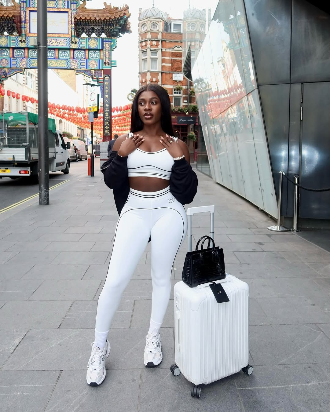 A black woman wearing athleisure wear by Berbie beauty via @berbiebeauty_ on Instagram.