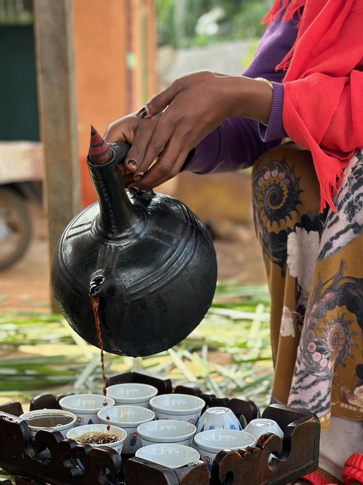  A Black Woman pouring coffee in a traditional manner by Cafes Di Costanzo via Pinterest