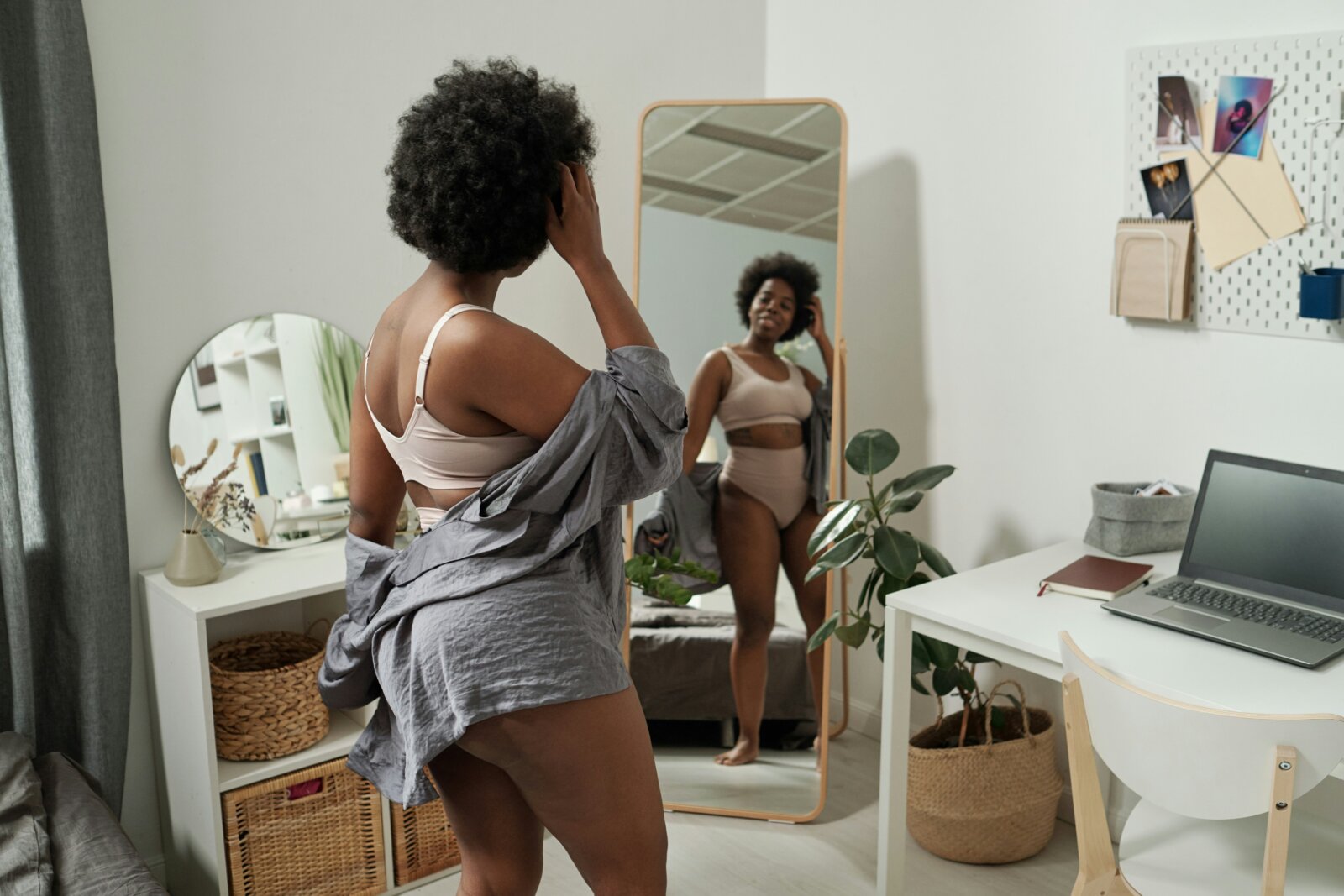 Personal beauty journey - young woman in underwear standing in front of large mirror in bedroom by getty images via unsplash