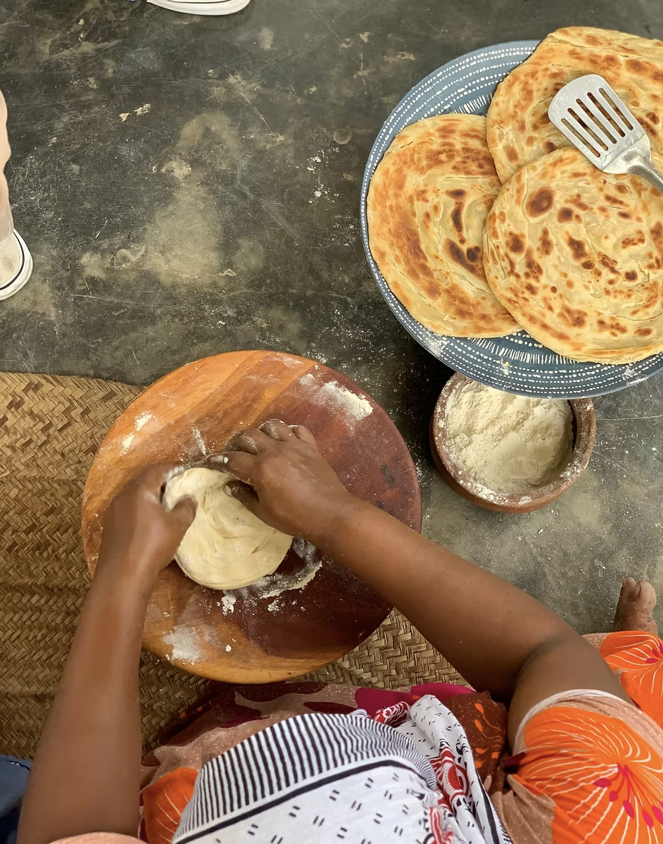 A woman making chapati at Mamas of Zanzibar @mamasofzanzibar via Instagram.