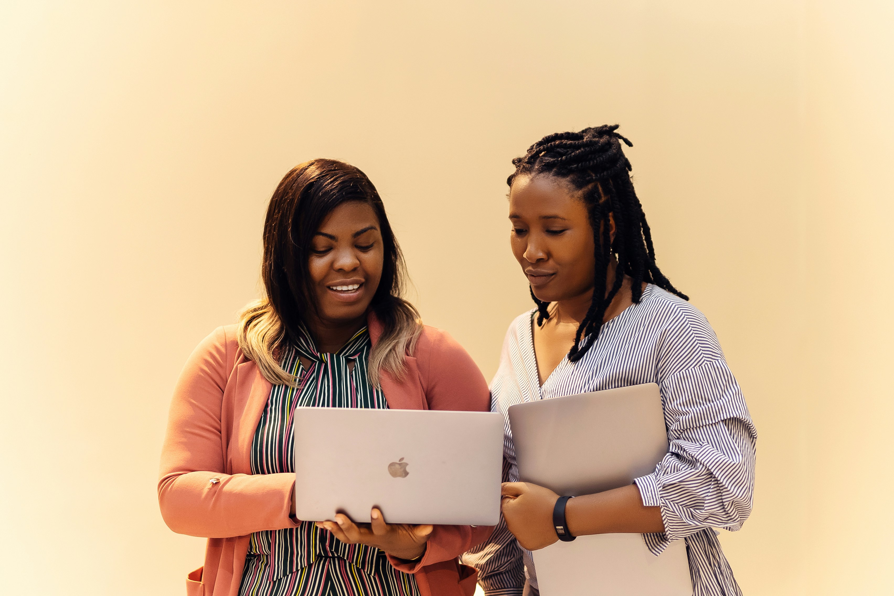 Two black women looking at laptops at work by Ninthgrid via Unsplash