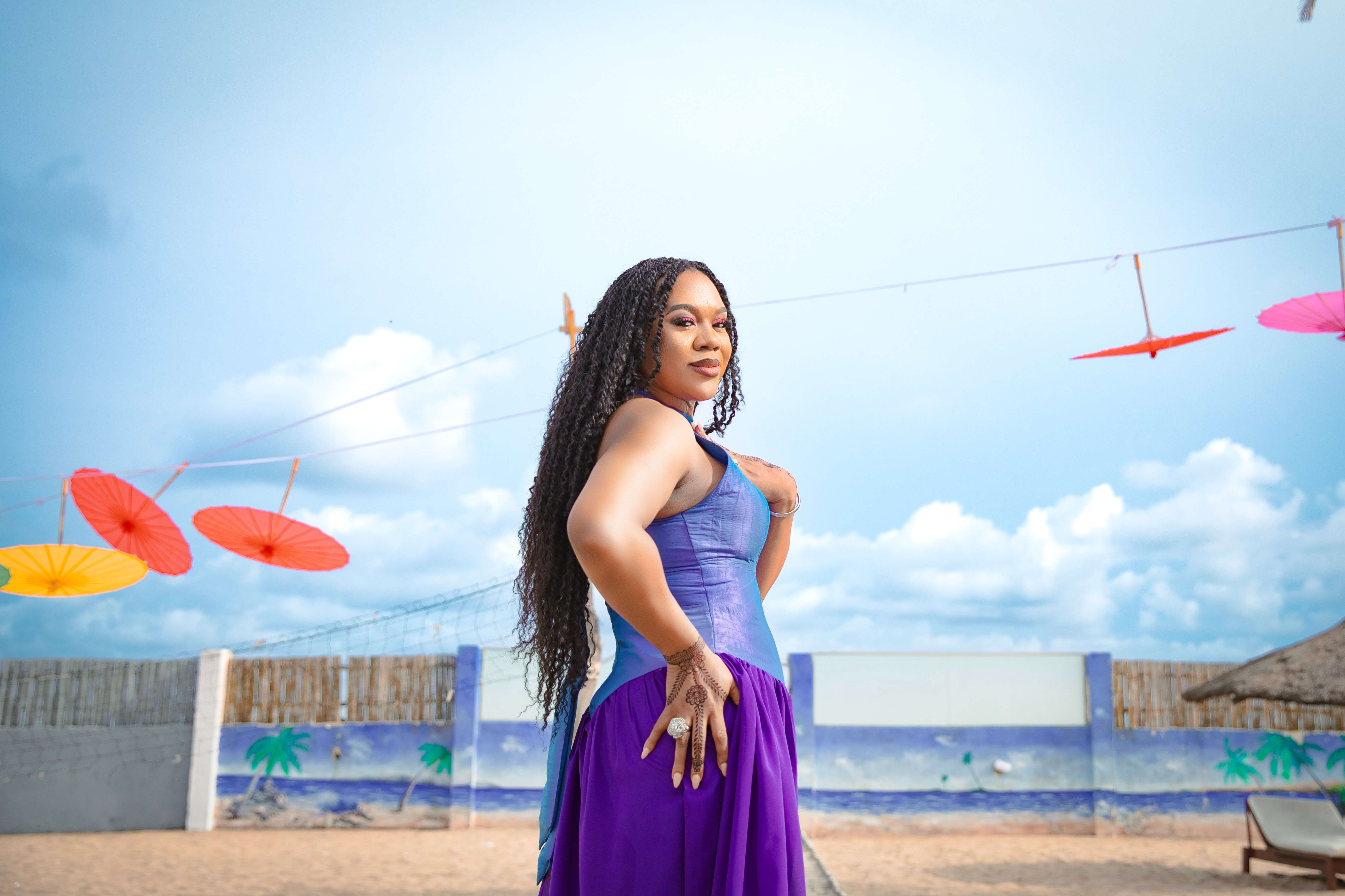 The veteran actress poses in a purple dress by IzzyBelle Images