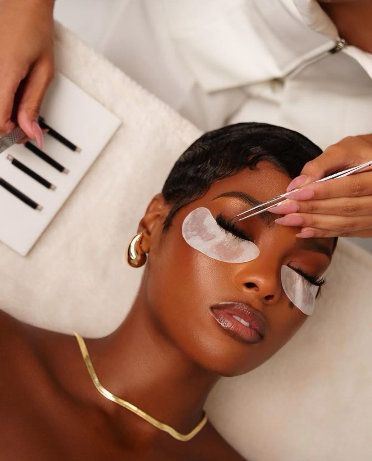 A black woman getting her lashes done via Pinterest