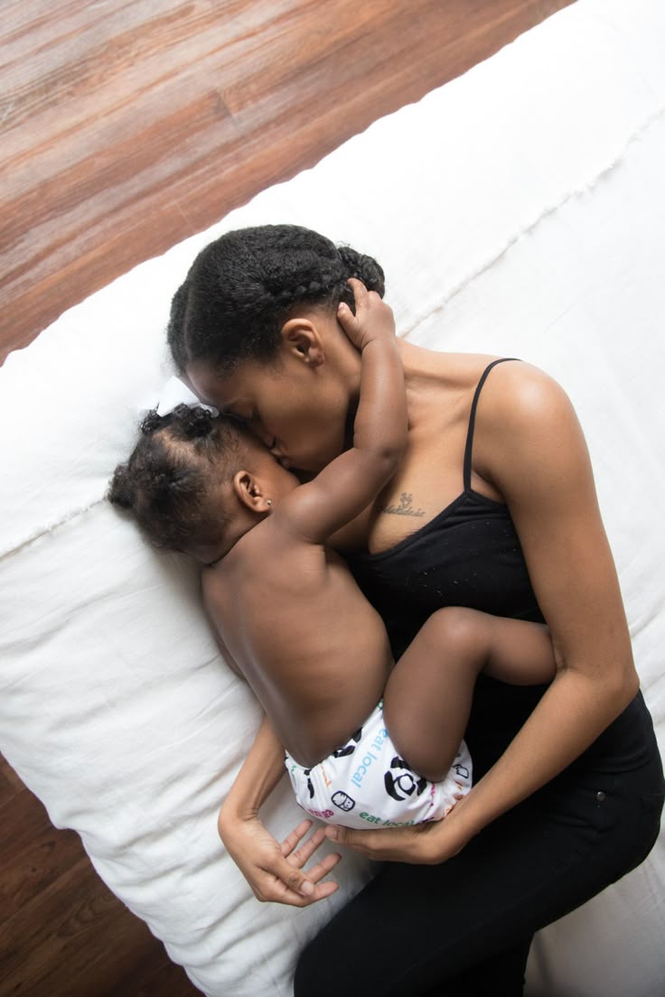 Black Woman cuddling her baby by Megan Flanagan via Pinterest 