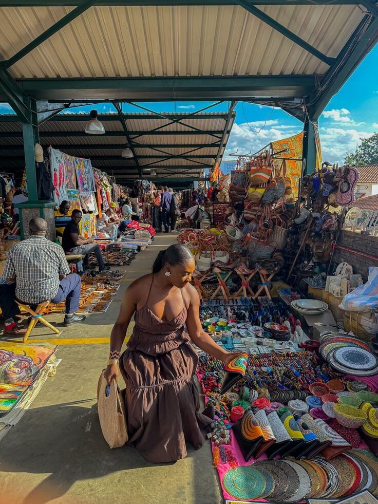 Black woman shopping for souvenirs at a local market via Pinterest
