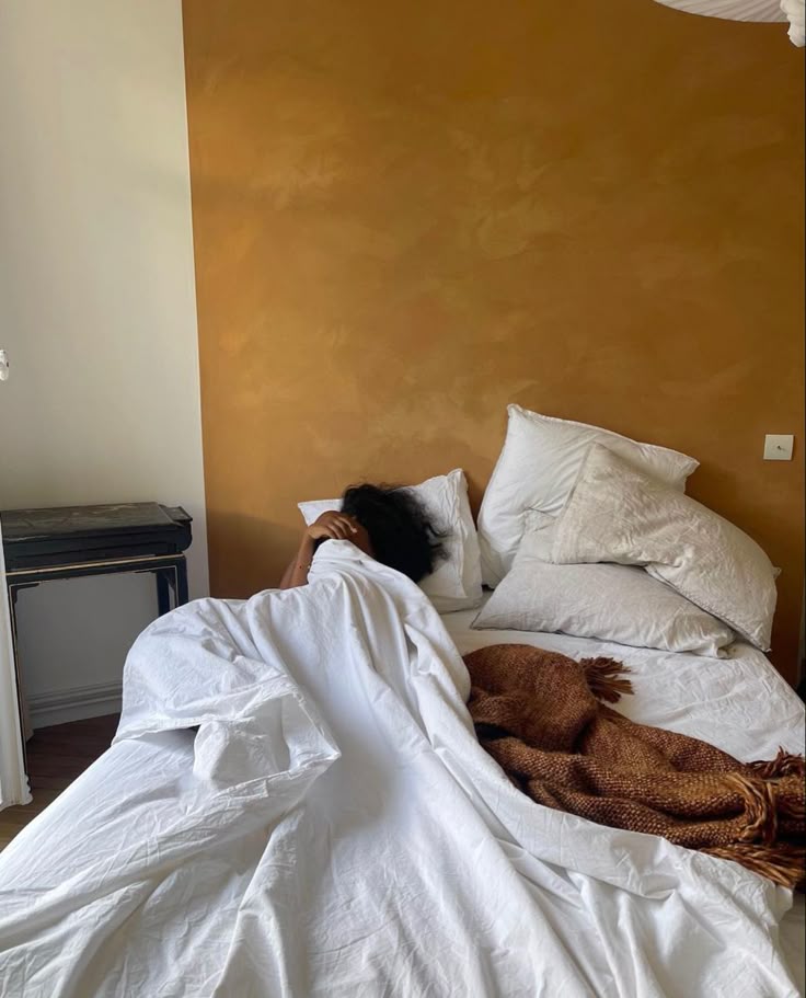 Black Woman lying in bed. Anxious on becoming a mom