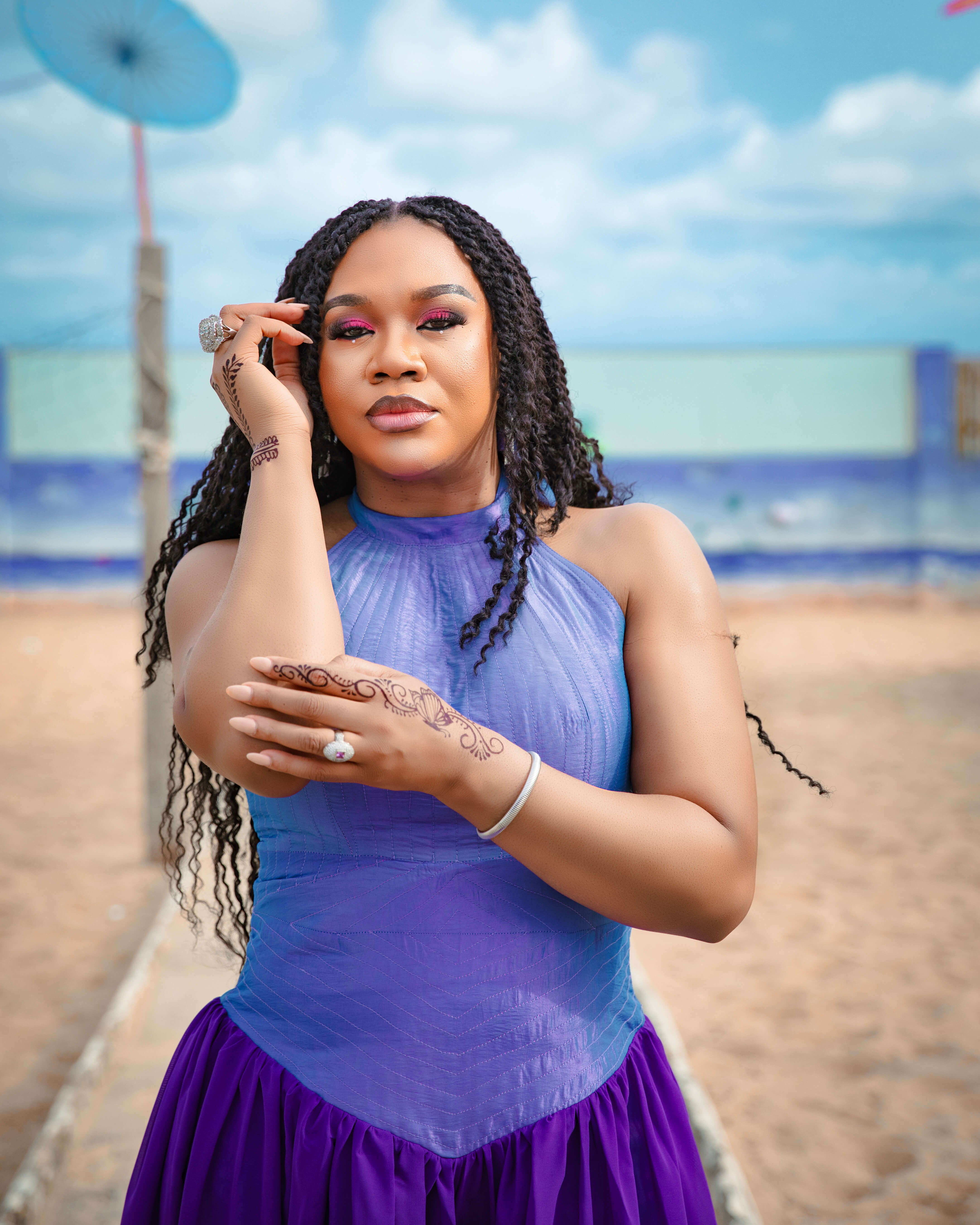 Stella Damasus posing in a purple dress by IzzyBelle Images