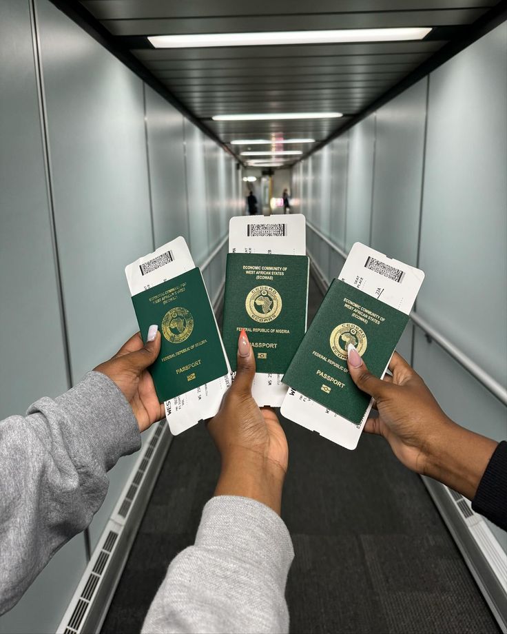 Three hands holding their Nigerian Passport getting ready to board a flight by Stephanie Moka via Pinterest passport fee