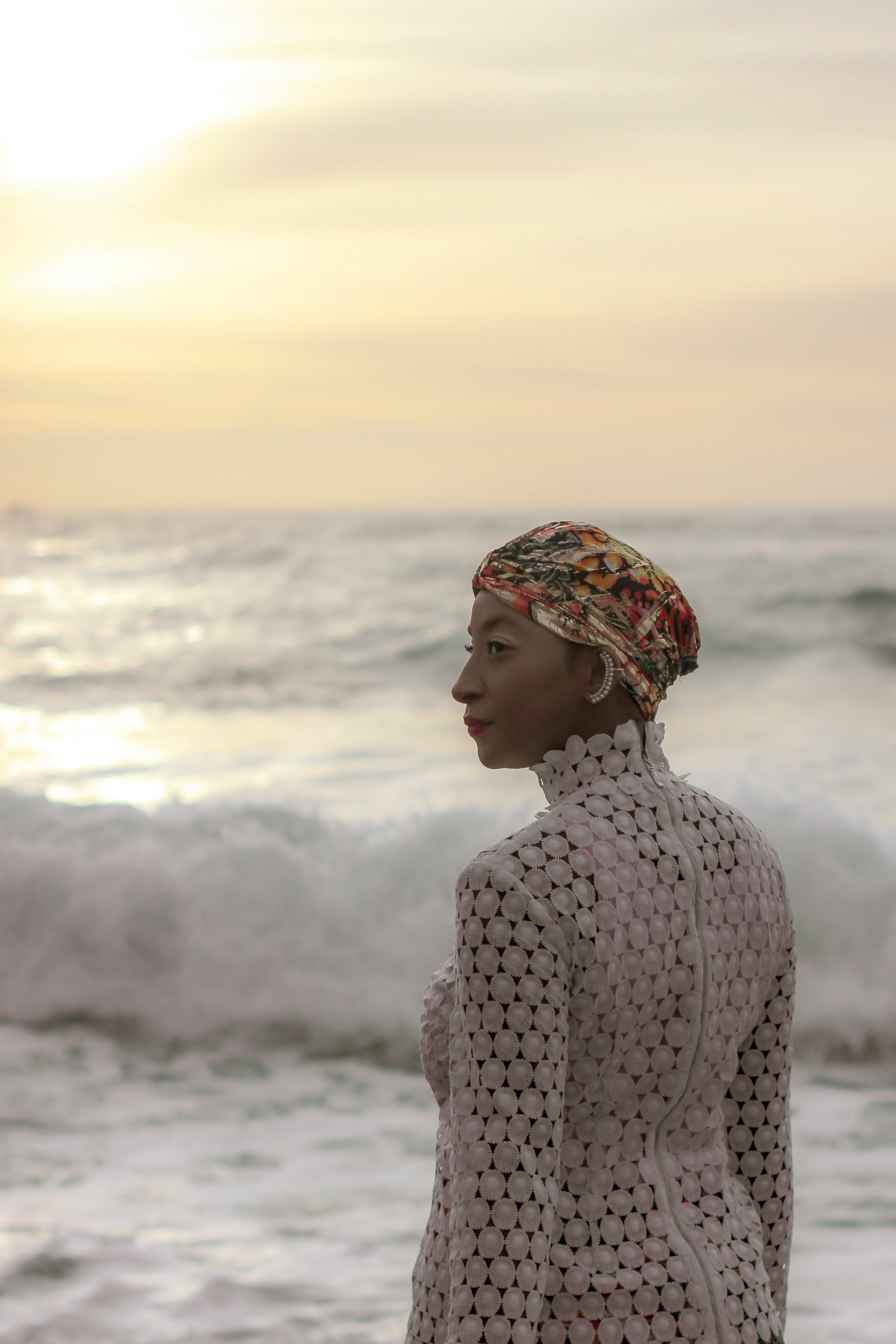 Black woman standing at the beach by Nataliya Melnychuk via Unsplash