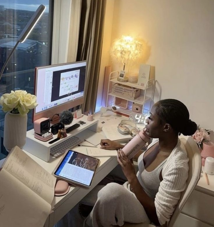 Black woman working on a MacBook and tablet via Pinterest (original creator unknown; if this is your work, please contact us for credit)