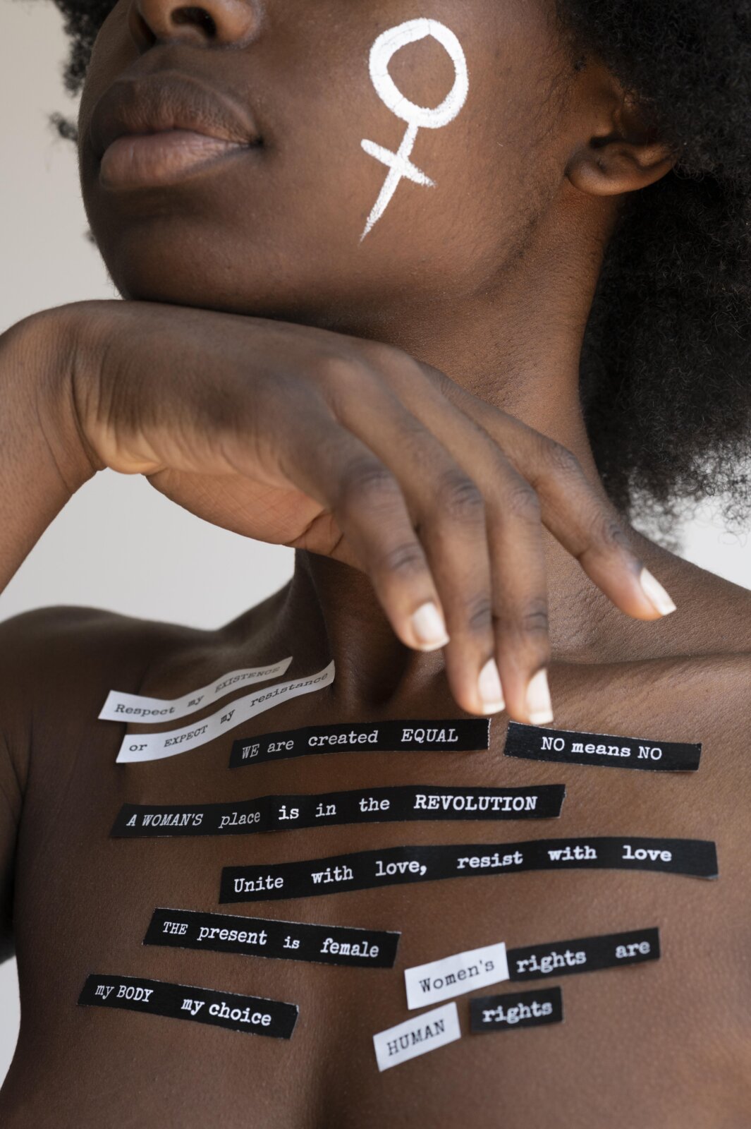 Black woman with inscriptions pasted on her body via Freepik