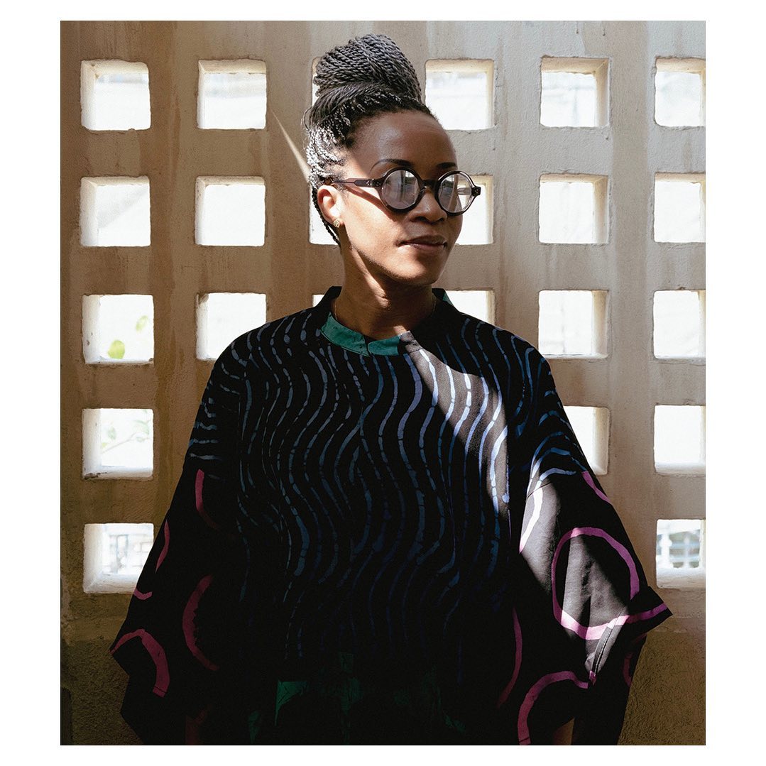 Portrait of Tosin Oshinowo with glasses and grey braids via @tosin.oshinown on Instagram
