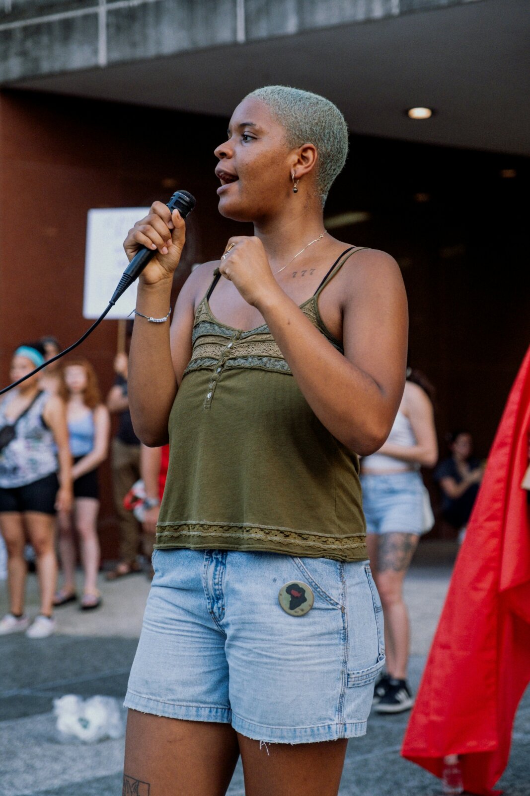  Neutral A Black woman speaking into the mic by Aiden Craver via Unsplash