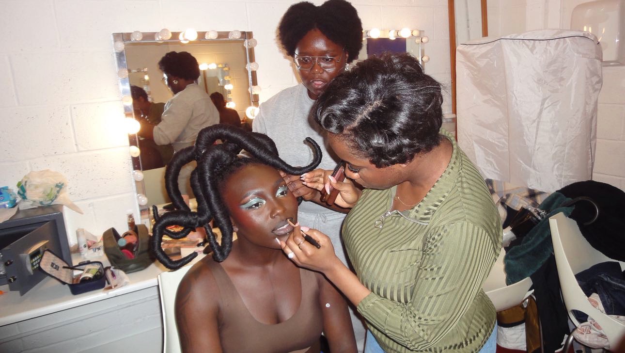 Portrait of Temitope Onayemi doing makeup on a model via Temitope Onayemi